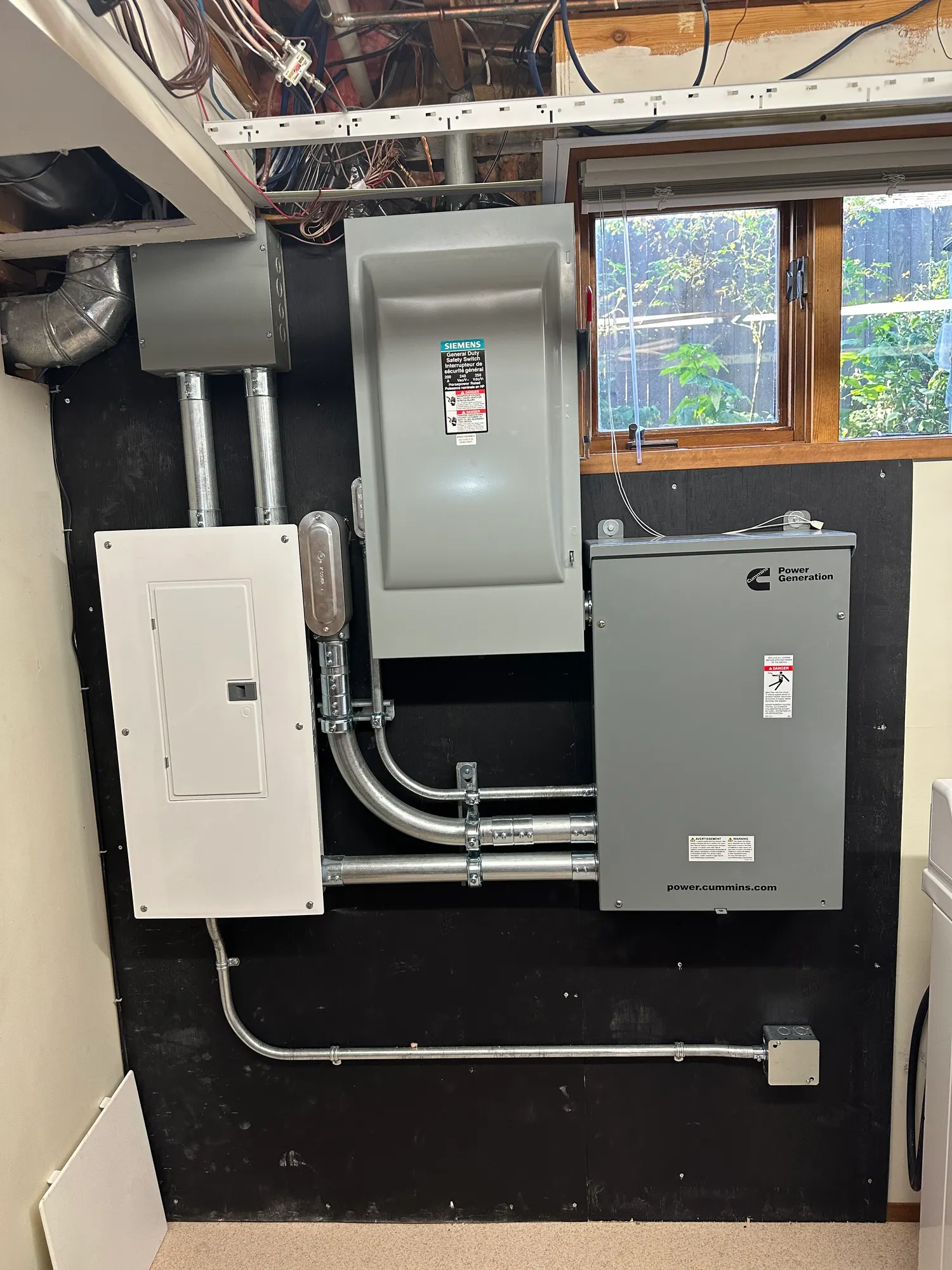 Finished generator transfer switch installation with covers on