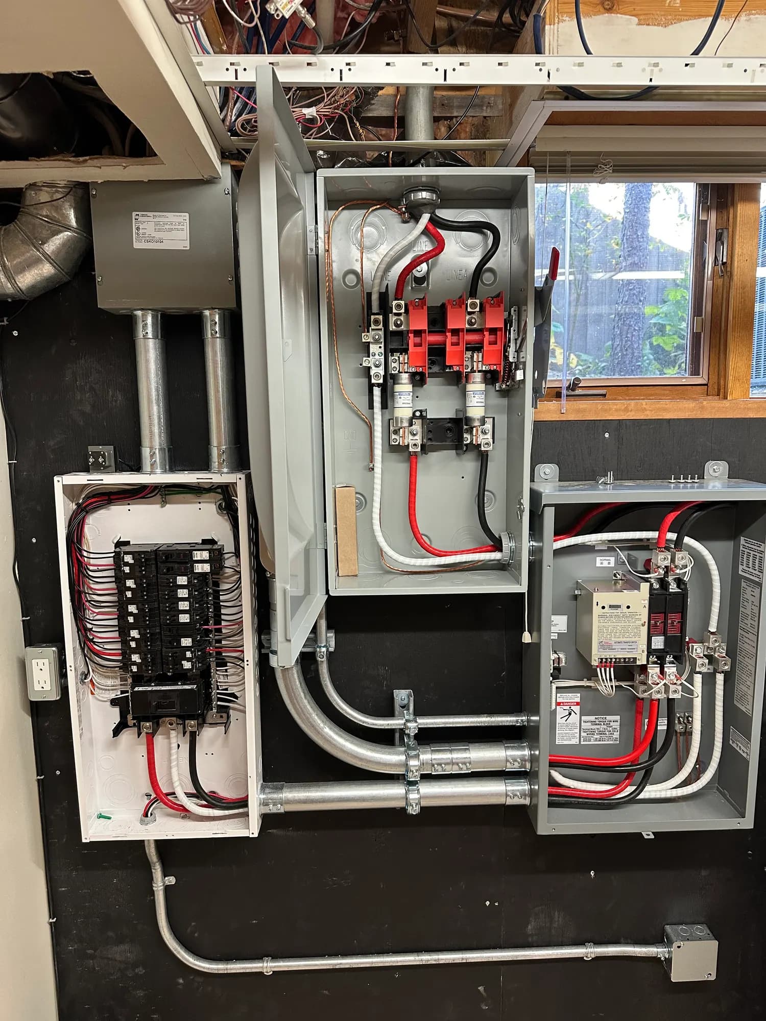 Transfer switch and panel with covers open showing the wiring