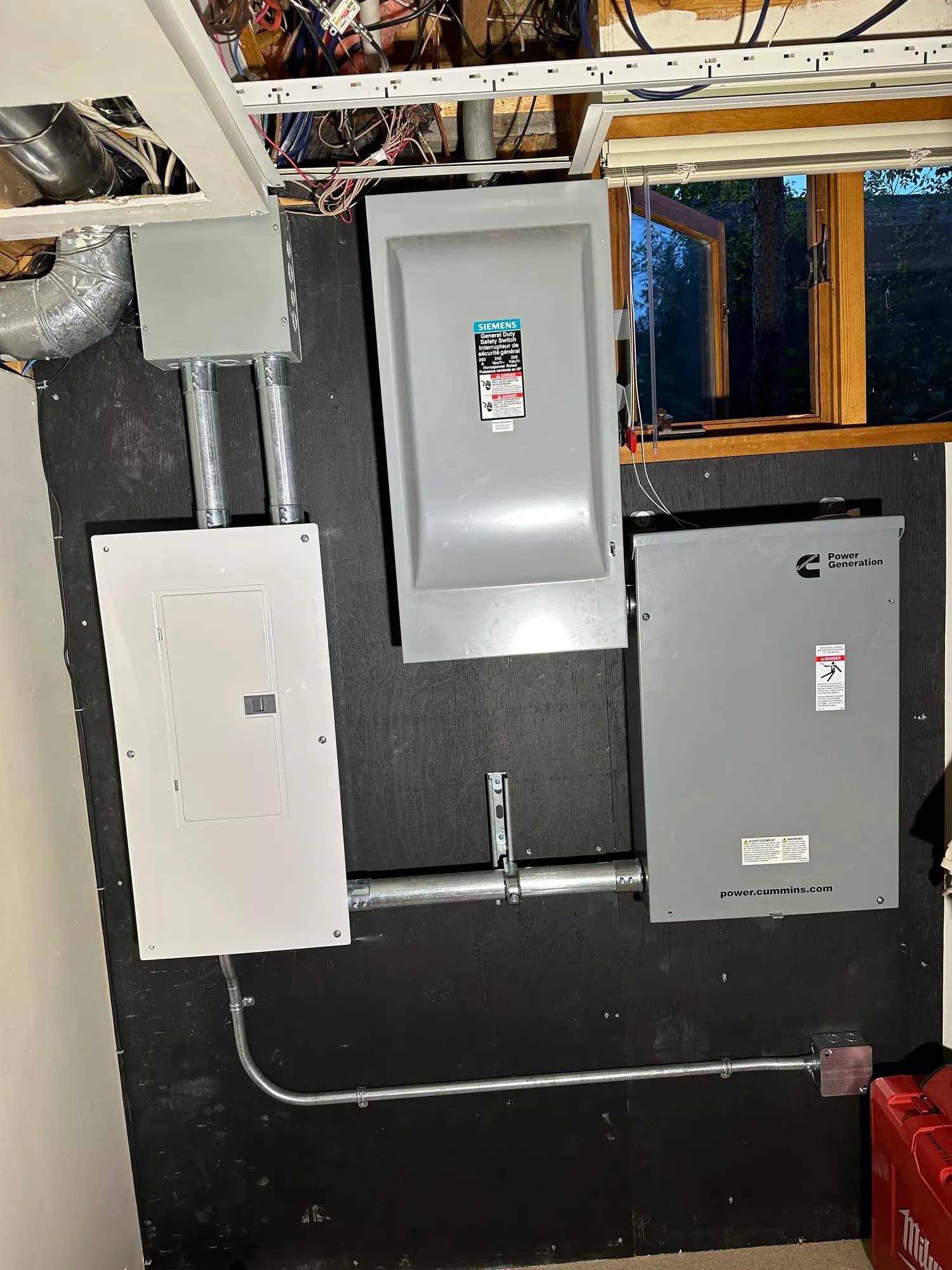 Generator transfer switch, disconnect and panel mounted on a backboard
