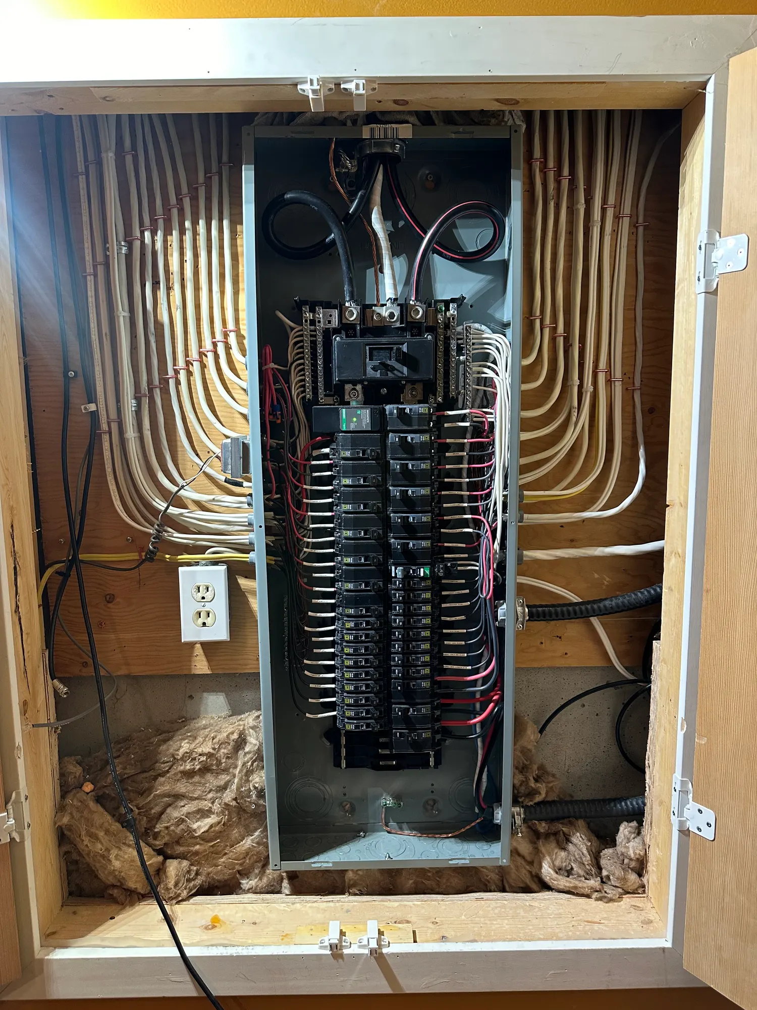 Recessed breaker panel with wiring neatly routed into a framed wall