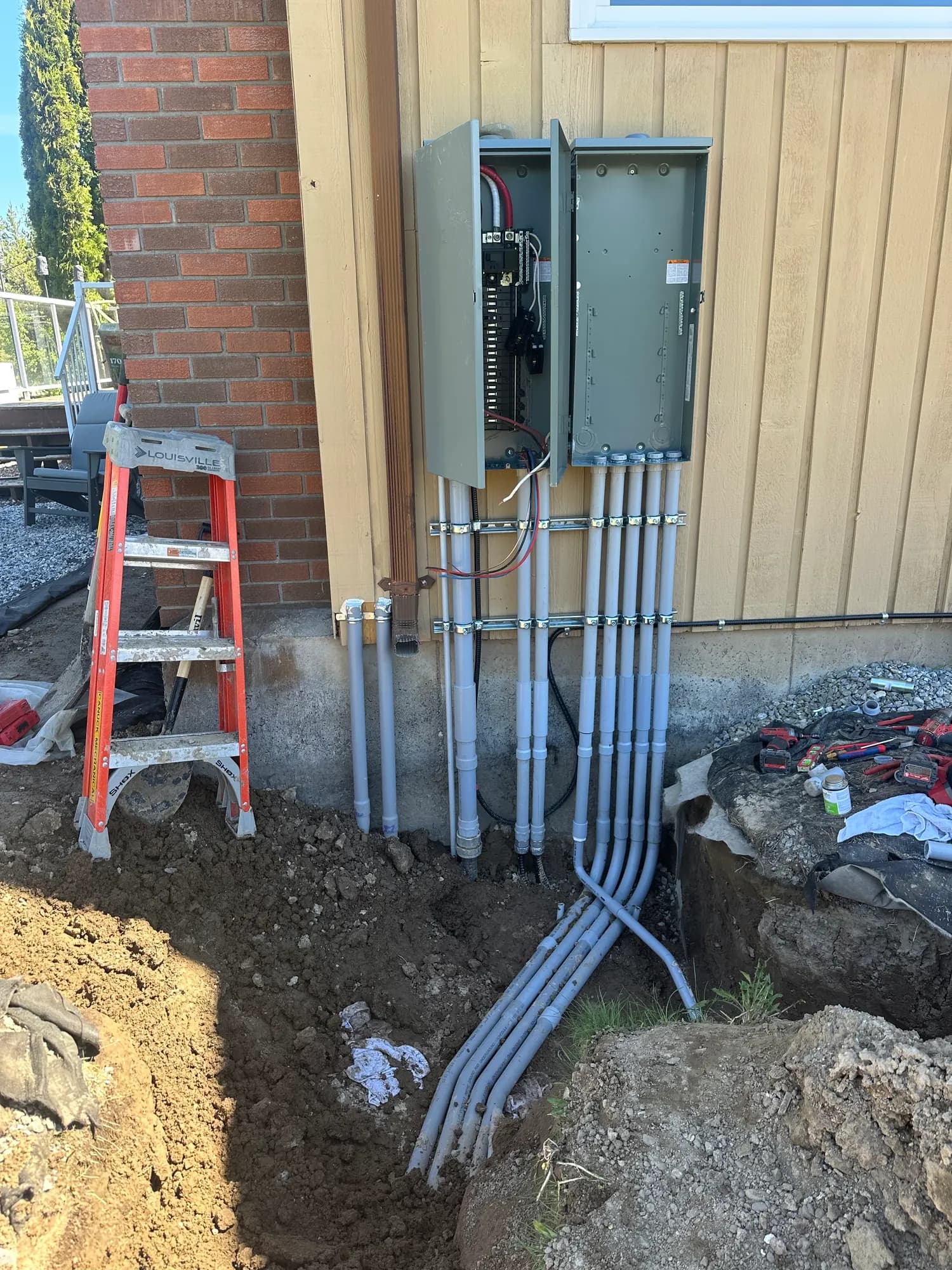 New meter base and disconnect mounted on a home's exterior wall