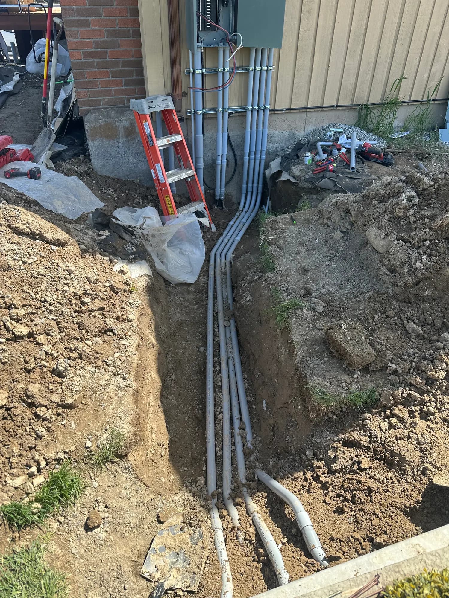 Underground conduit trench for a residential service upgrade